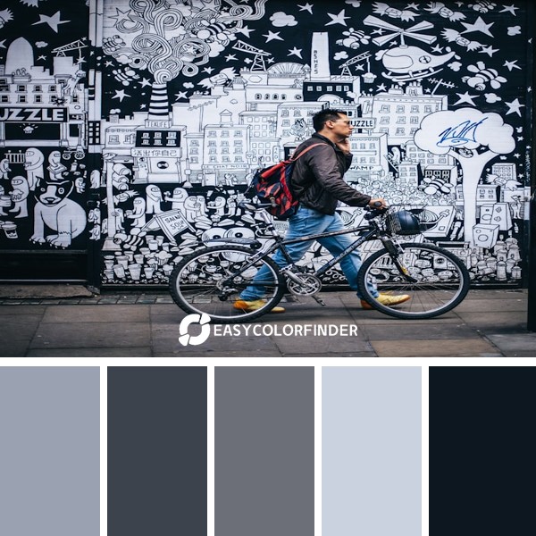 Man with bike in front of street art