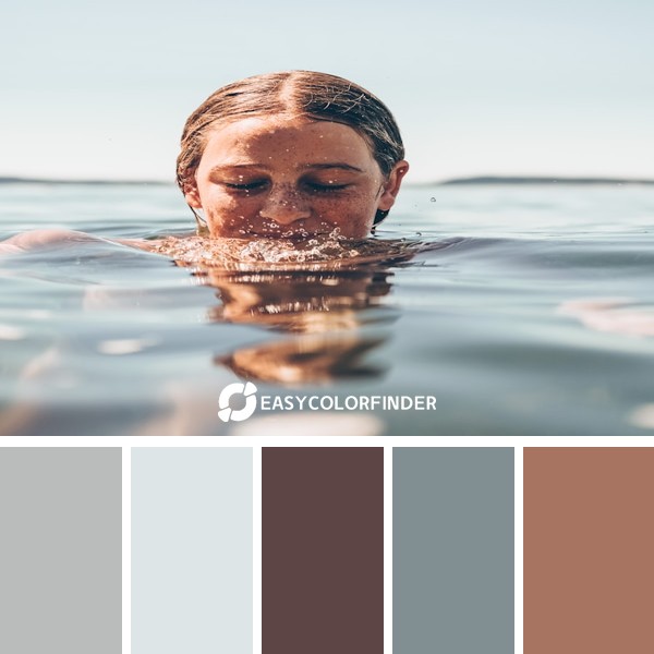 Teenage girl in the ocean with her head partially out of the water.
