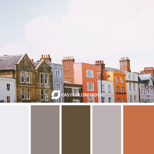 assorted-color concrete houses under white clouds during daytime
