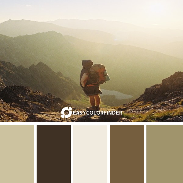 climber standing on rock near overlooking view of mountain at daytime