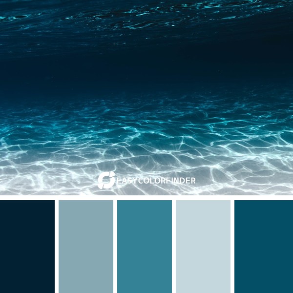 grey sand under blue clear water