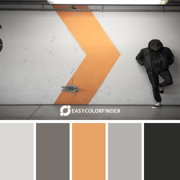 man leaning on white wall of the parking area