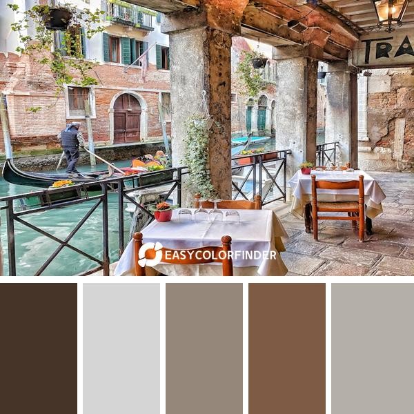 man riding on boat beside restaurant