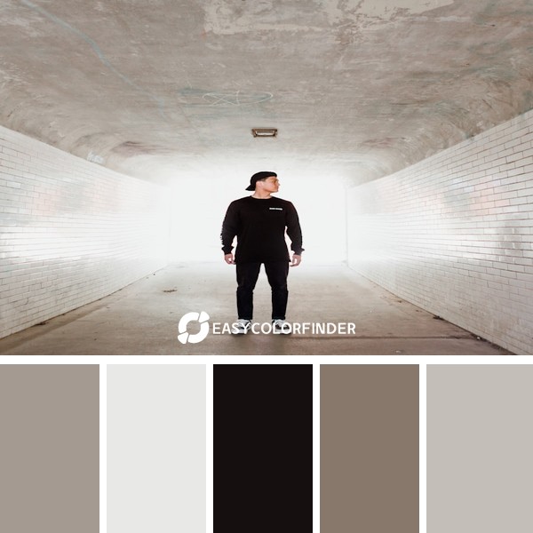 man standing in building with white walls looking on his left side