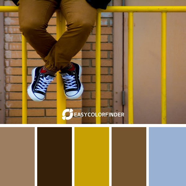 person sitting on rail fence
