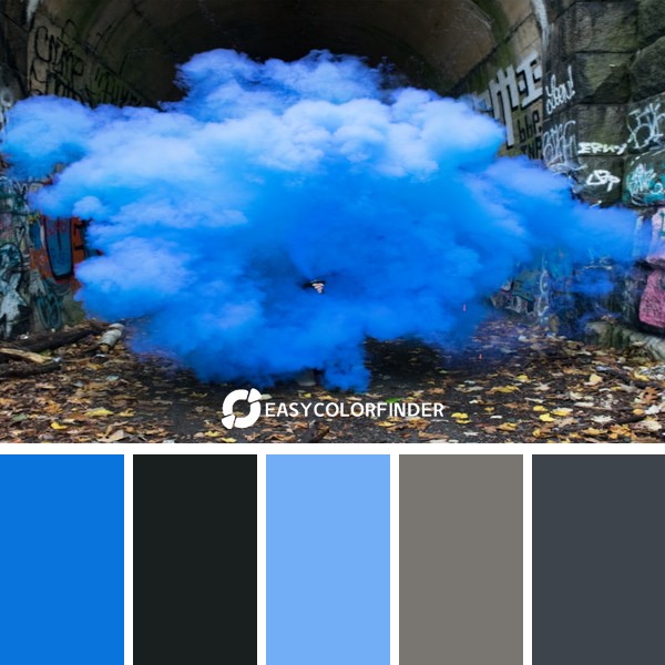 photo of blue smoke beside walls with graffiti