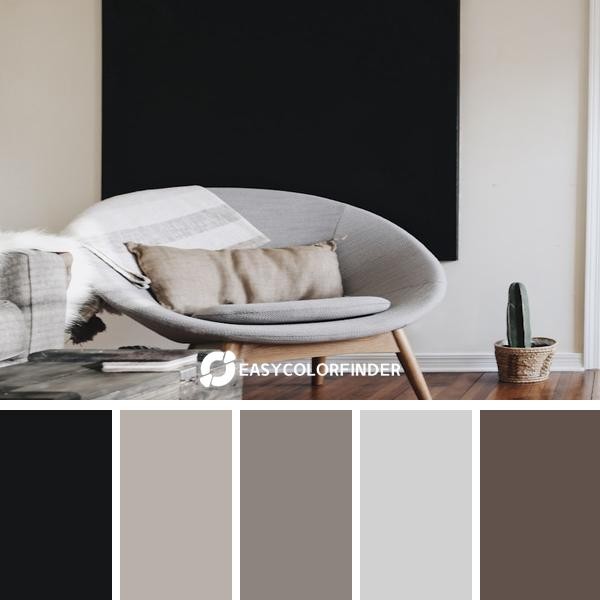 round grey moon chair with brown pillow on top