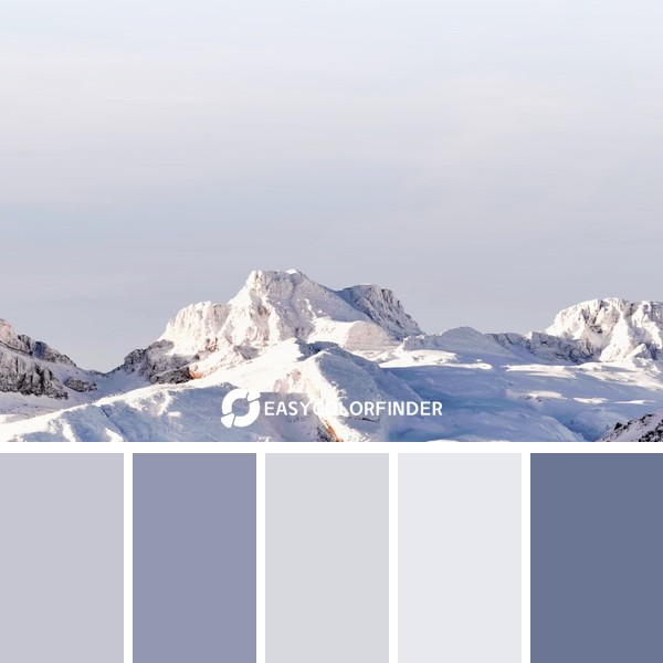 snow covermountains under gray sky