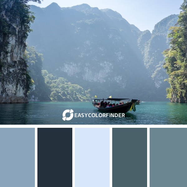 white boat in between rocky mountains