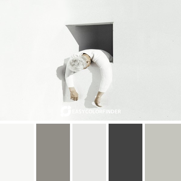 woman in white long sleeve shirt and white pants lying on white wall
